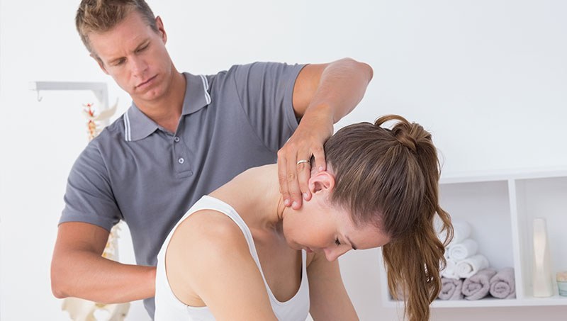 Woman being treated by chiropractor for auto accident injury